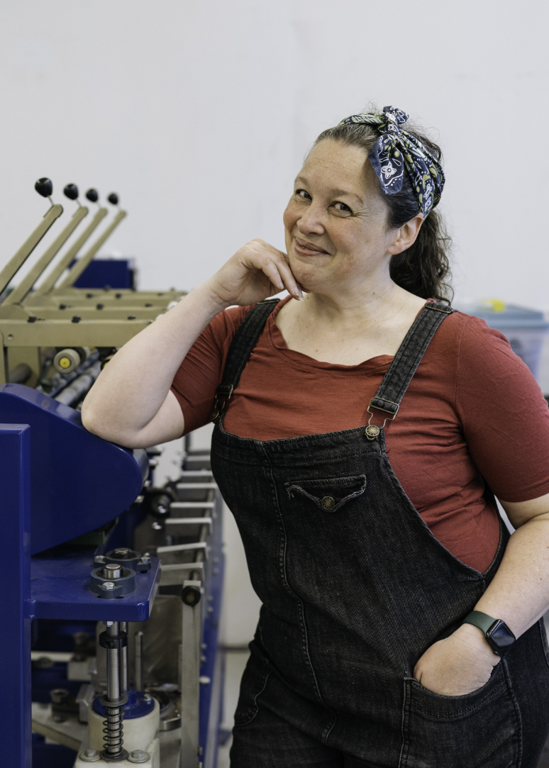 woman cleaning carder at fiber mill